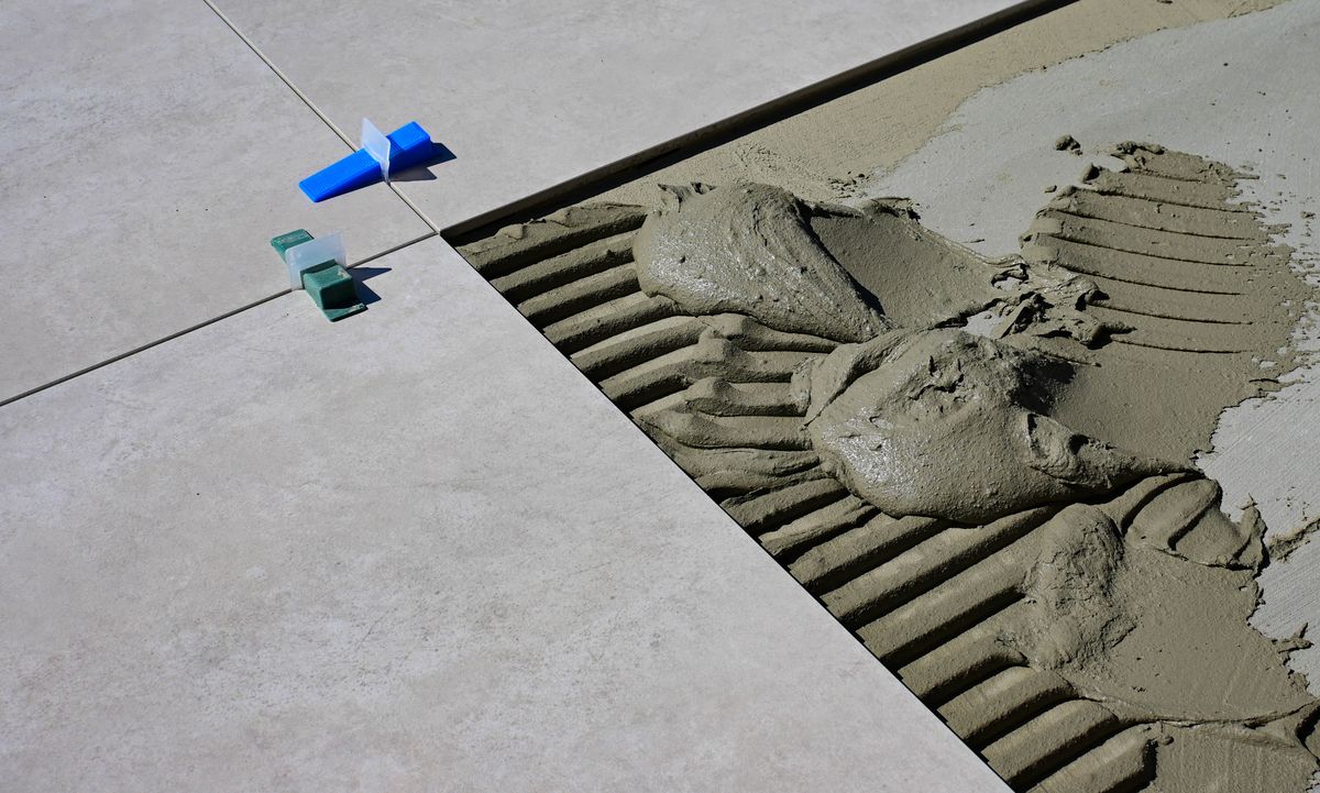 Tile installation with adhesive